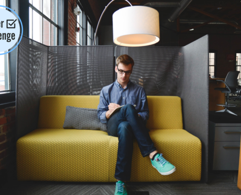 A man sitting on top of a yellow couch.