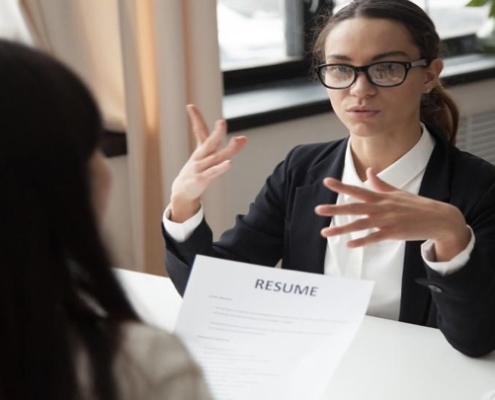 A woman in glasses is talking to someone