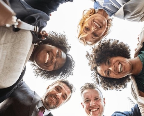 A group of people standing in a circle smiling for the camera.