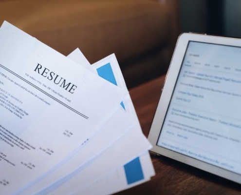 A tablet and papers on the table