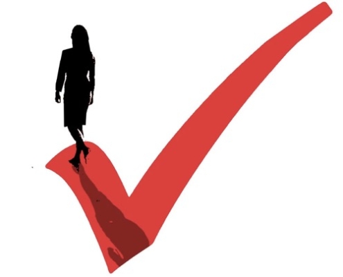 A woman standing on top of a red check mark.