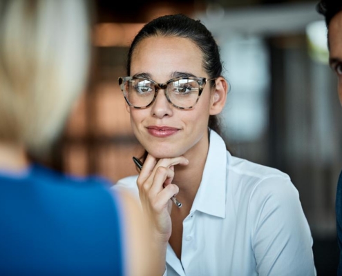 A woman wearing glasses and sitting at a table