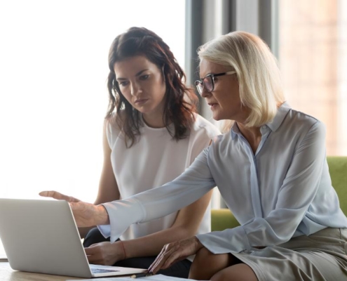 Two women looking at a laptop screen