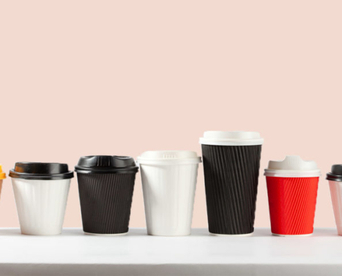 A row of coffee cups sitting on top of a table.