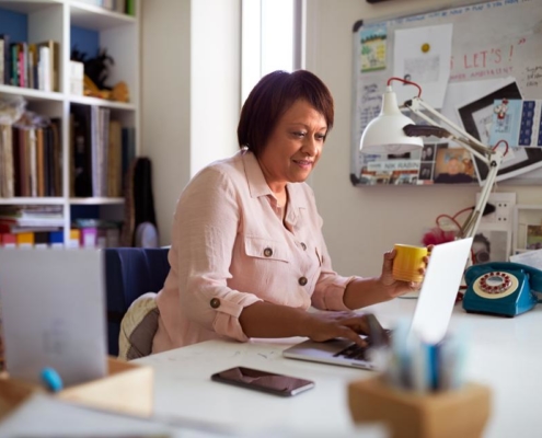 A woman sitting at her desk with a laptop.