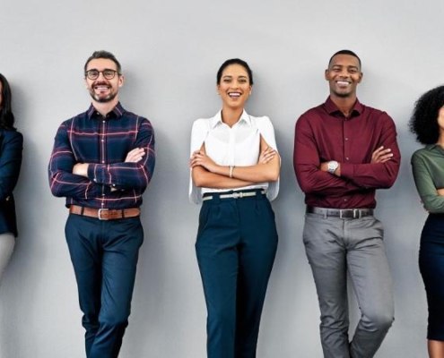 Three people standing in a line with their arms crossed.