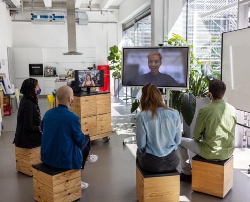 A group of people sitting in front of a tv.